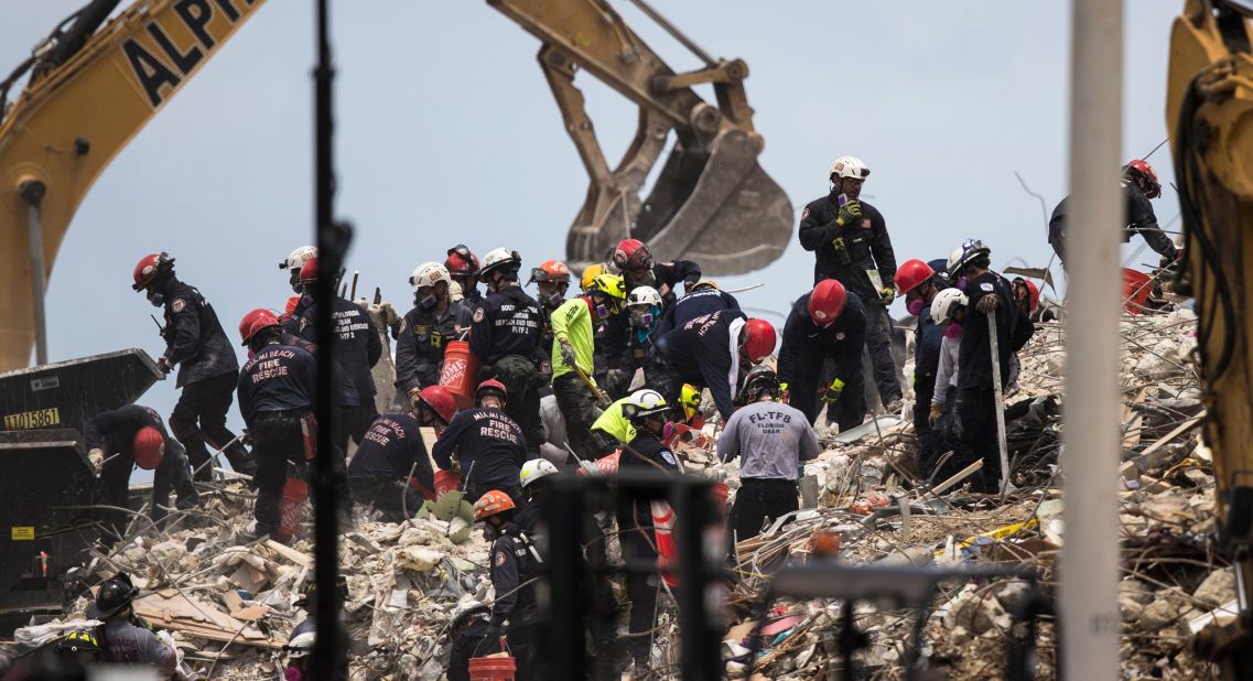 Crews work at the site of the collapsed building on July 6.