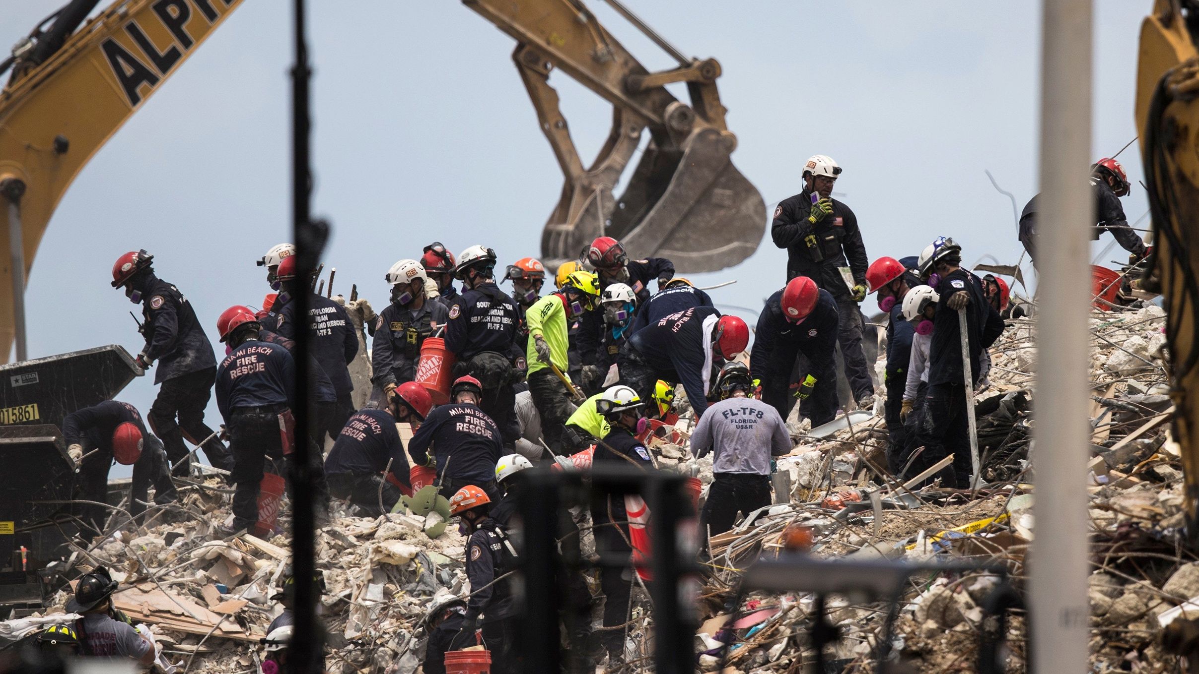 Crews work at the site of the collapsed building on July 6.
