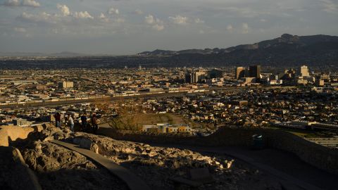 People look towards the downtown El Paso and the US-Mexico border separating El Paso and the Mexican city of Ciudad Juarez, Chihuahua state, Mexico, from Murchison Rogers Park along Scenic Drive at sunset on June 24, 2021 in El Paso, Texas.