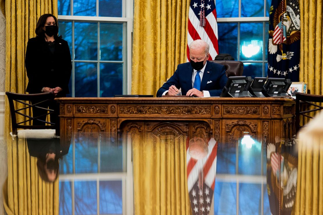 President Joe Biden signs several executive orders on immigration on February 2 in the Oval Office.
