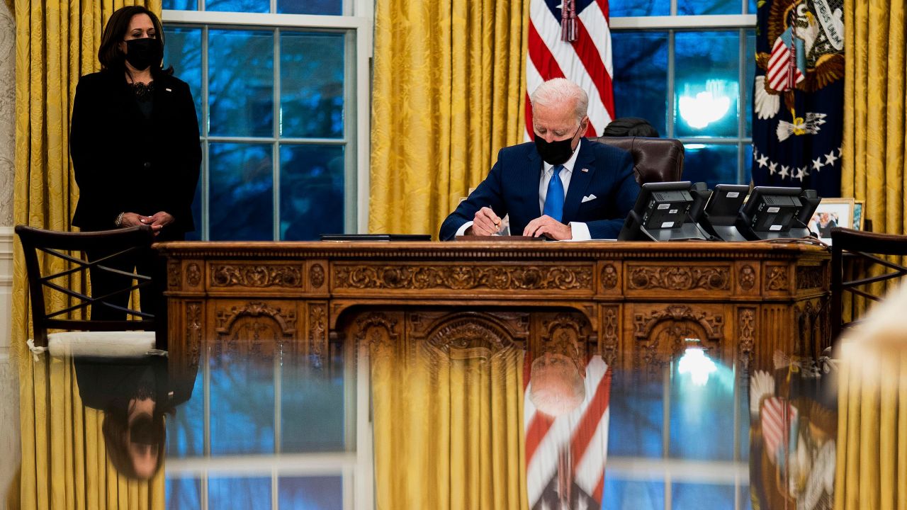 President Joe Biden signs several executive orders on immigration on February 2 in the Oval Office.