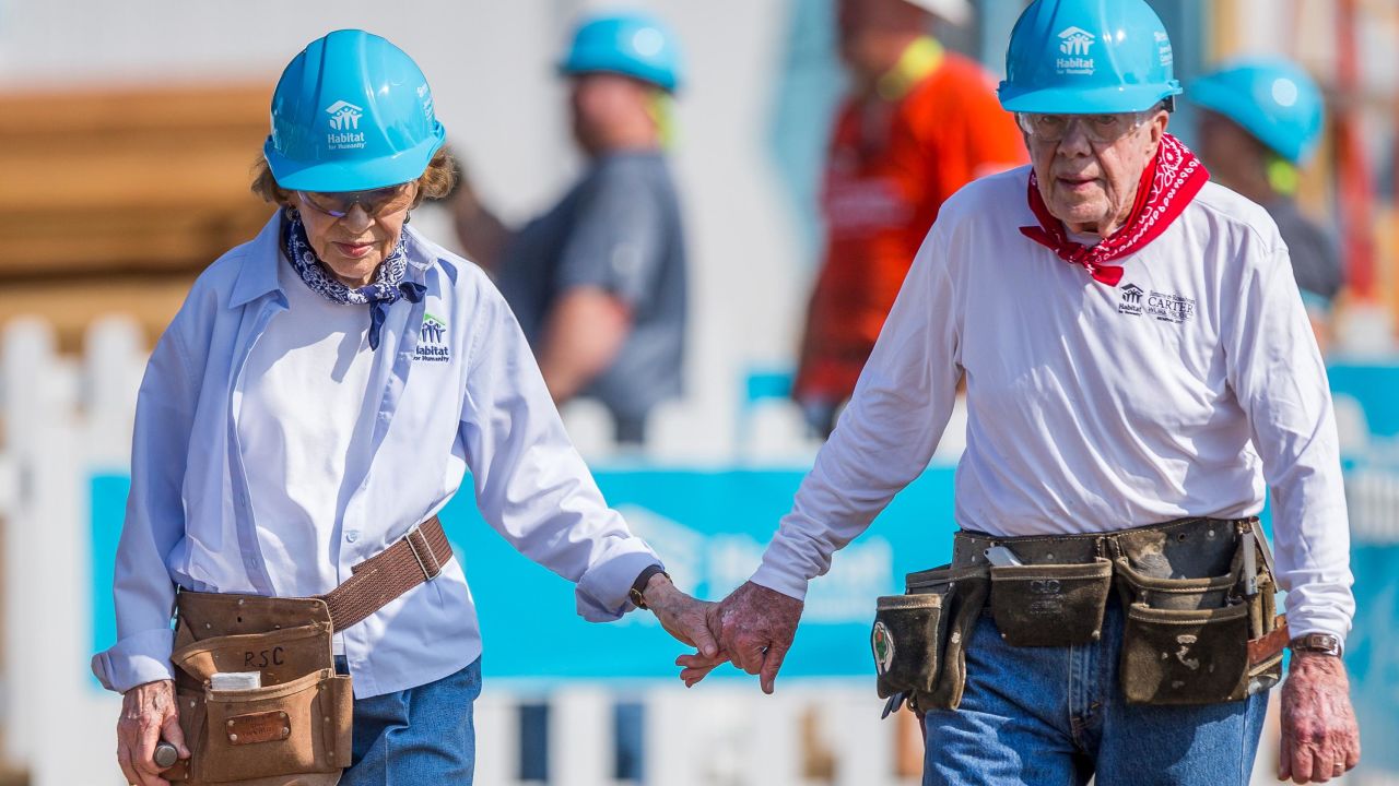 Jimmy and Rosalynn Carter hold hands as they work with other volunteers on site during the first day of the weeklong Jimmy & Rosalynn Carter Work Project, their 35th work project with Habitat for Humanity, in Mishawaka, Indiana in 2018.