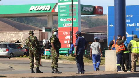 eSwatini soldiers and police officers are seen on the streets near the Oshoek Border Post between Eswatini and South Africa on July 1, 2021. 