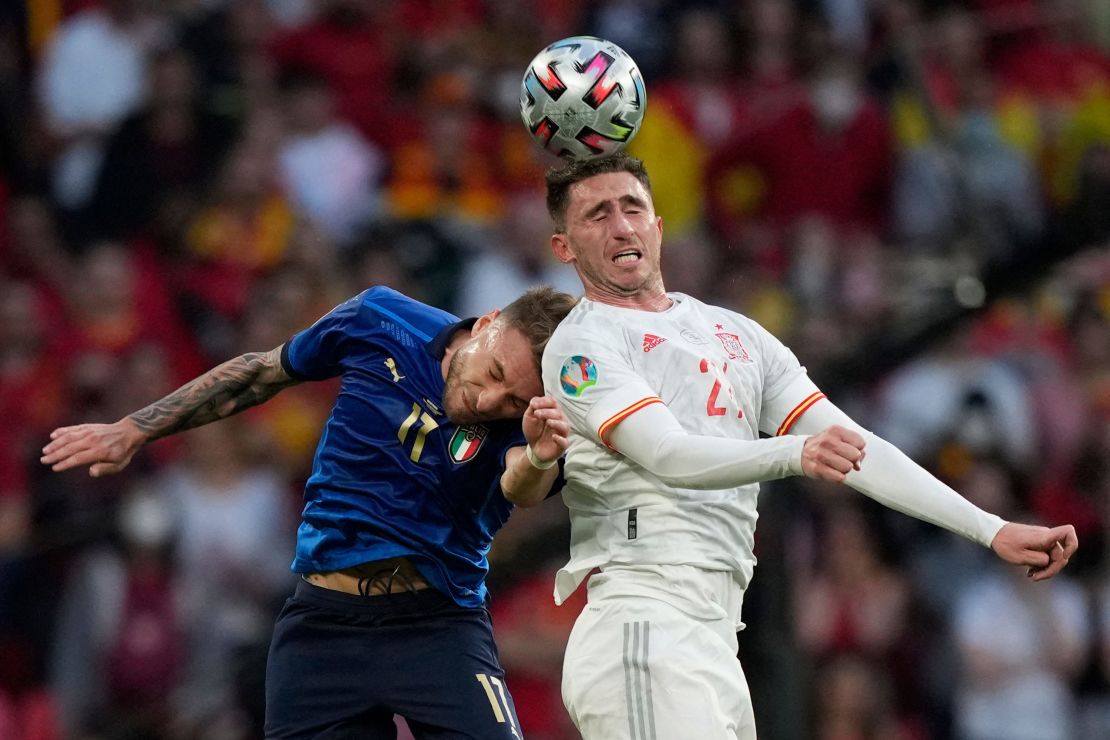 Spain's Aymeric Laporte and Italy striker Ciro Immobile compete for the ball.