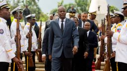 FILE - In this April 7, 2018, file photo, Haiti's President Jovenel Moise, center, leaves the museum during a ceremony marking the 215th anniversary of revolutionary hero Toussaint Louverture's death, at the National Pantheon museum in Port-au-Prince, Haiti. Moïse was assassinated after a group of unidentified people attacked his private residence, the country's interim prime minister said in a statement Wednesday, July 7, 2021. (AP Photo/Dieu Nalio Chery, File)