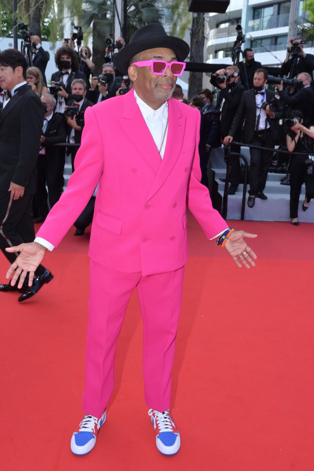 Jury president and American director Spike Lee wore a hot pink Louis Vuitton suit and custom red, white and blue Air Jordan 1 PE sneakers.
