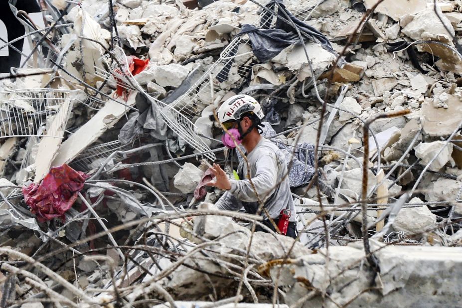 A member of a search team moves rubble at the site on July 7. Authorities transitioned from search and rescue to search and recovery after determining "the viability of life in the rubble" was low, Miami-Dade County Fire Chief Alan Cominsky said.