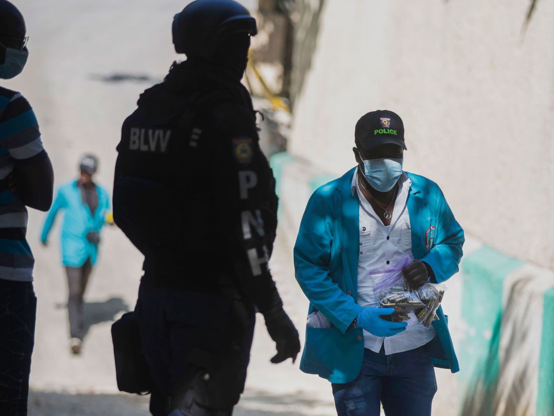 A forensic investigator carries a bagful of bullet casings collected at the residence of Haiti's President Jovenel Moise in Port-au-Prince, Haiti, on July 7.