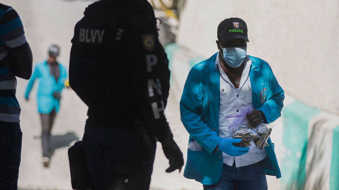 A forensic investigator carries a bagful of bullet casings collected at the residence of Haiti's President Jovenel Moise in Port-au-Prince, Haiti, on July 7.