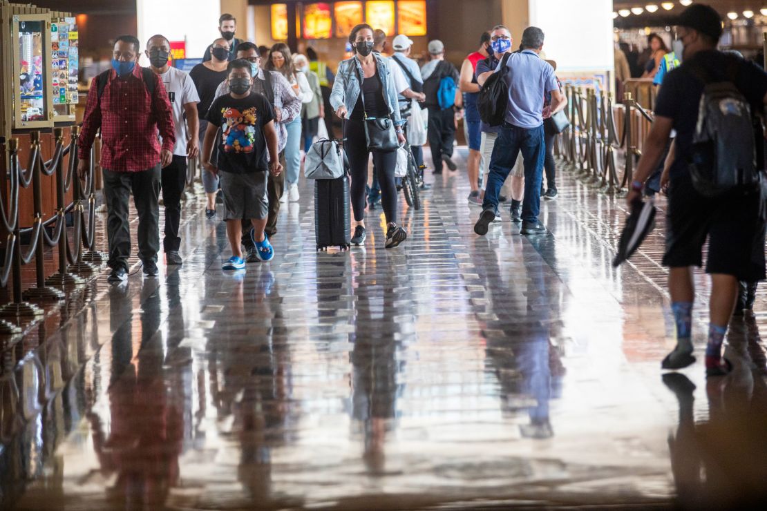 Wearing face masks, people walk last month through Union Station in Los Angeles. California is one of the 24 states seeing an uptick in Covid-19 cases. 