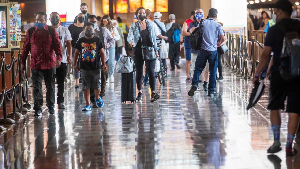 Wearing face masks, people walk last month through Union Station in Los Angeles. California is one of the 24 states seeing an uptick in Covid-19 cases. 