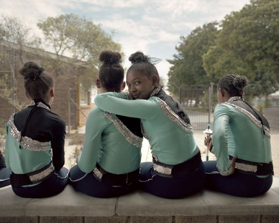 Mann describes the school drum majorette teams as a sisterhood. Here Hilce Rhode, from the Helderkruin Primary Majorettes, looks over her team leader Eden Adolph's shoulder, Cape Town, 2018.