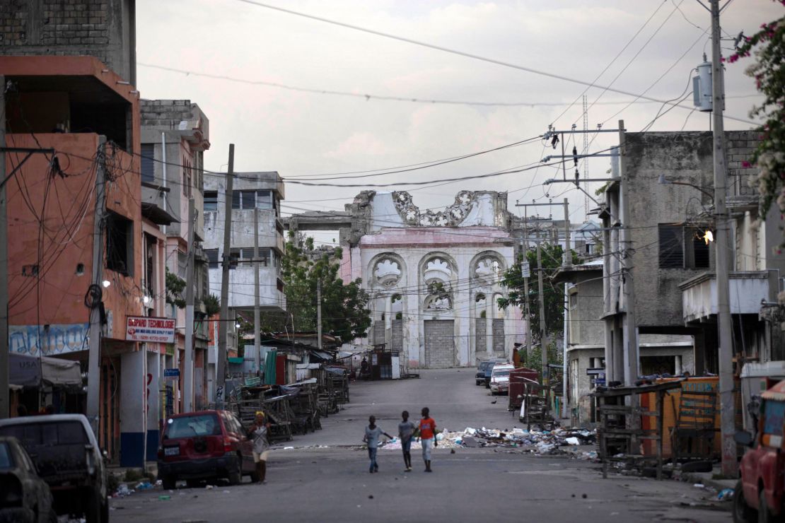 Children walk on an empty street in front of the cathedral that was destroyed by the 2010 earthquake in Port-au-Prince, Haiti, Wednesday.