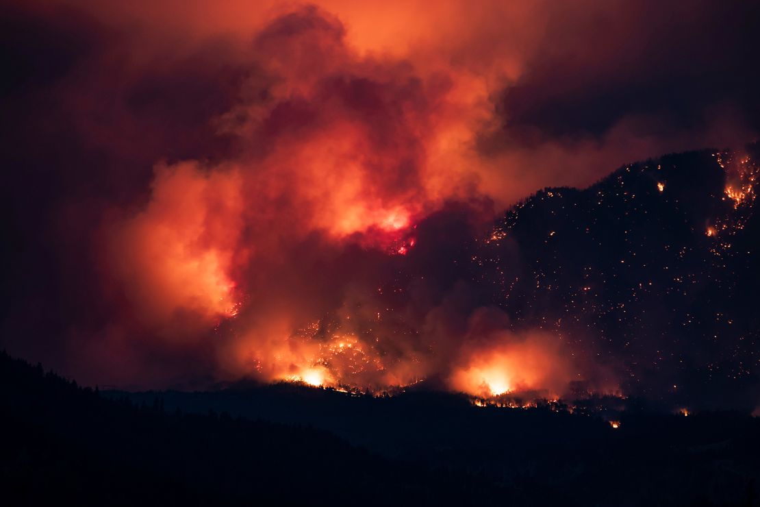 A wildfire burns on the side of a mountain in Lytton, British Columbia, on July 1.