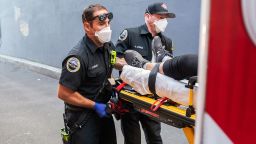 Paramedics Cody Miller, left, and Justin Jones respond to a heat exposure call during a heat wave, Saturday, June 26, 2021, in Salem, Ore. (AP Photo/Nathan Howard)