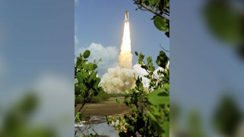 Space shuttle Discovery and its seven-member crew launch on July 26, 2005, the first shuttle mission after the Columbia disaster.