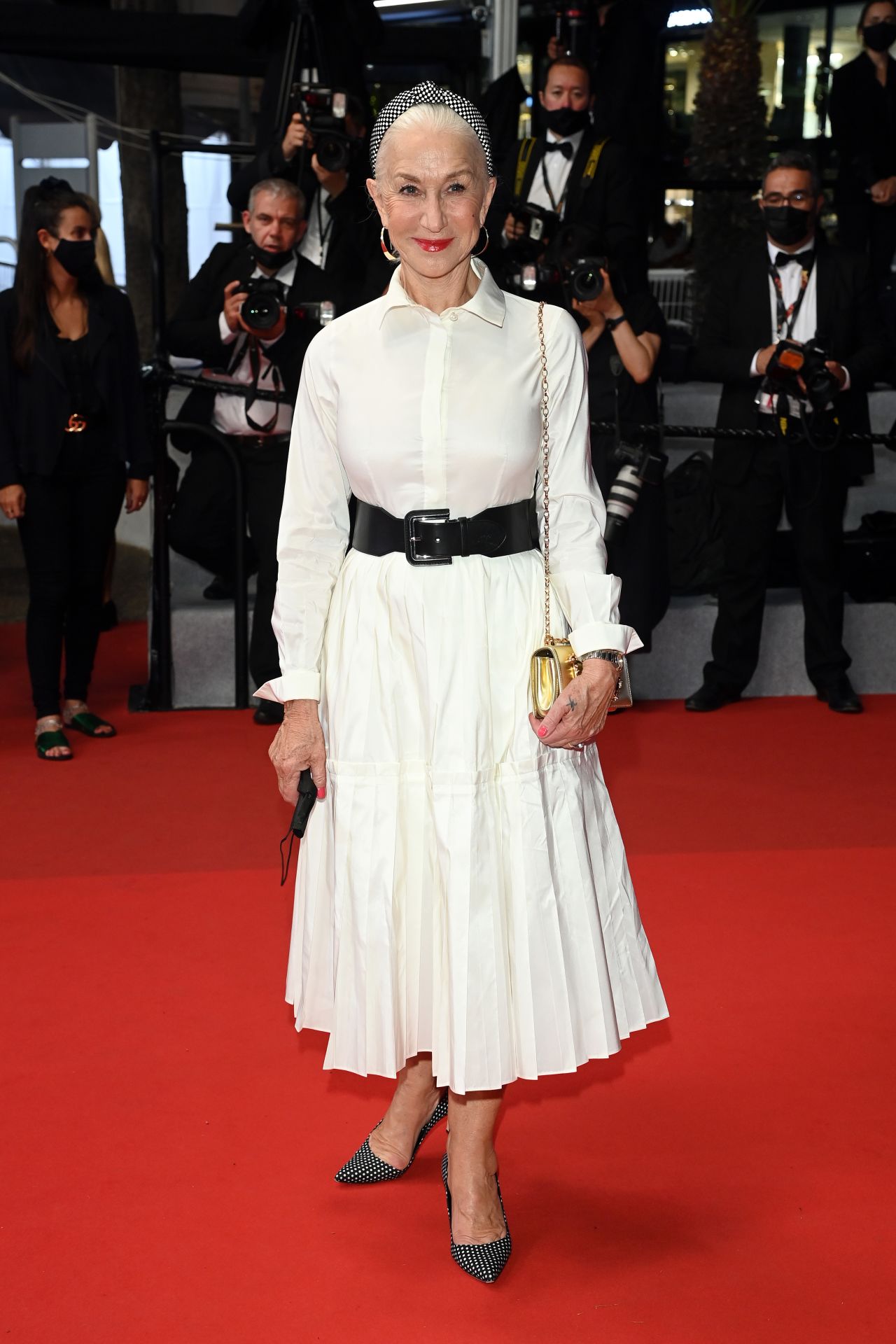Dame Helen Mirren walked the red carpet in a white Carolina Herrera shirt-dress cinched at the waist.