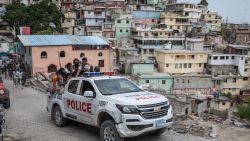 A police car filled with civilians and police in the Jalousie township on on July 8, in Haiti.  (Photo by Valerie Baeriswyl/AFP/Getty Images
