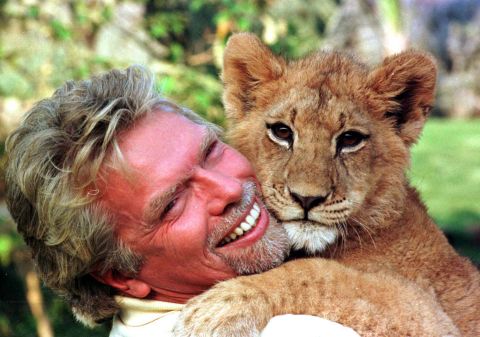 Branson cuddles with a young lion cub at South Africa's Sun City resort in 1996.