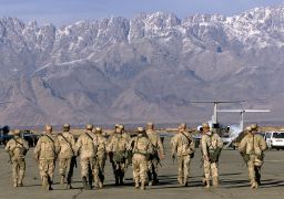 In this file photo taken on January 15, 2002, American service members approach United Nations planes on the tarmac of Bagram air base. 
