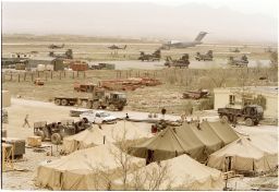 US military aircraft populate the runways of Bagram air base while tents are set up in the foreground on April 4, 2002.