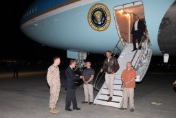 President Barack Obama is greeted by US Ambassador to Afghanistan James Cunningham, second from left, and Marine Gen. Joseph Dunford, left, commander of the US-led International Security Assistance Force, as he steps off Air Force One at Bagram air base for an unannounced visit on May 25, 2014.