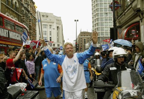 Branson runs with the Olympic torch in London in 2004, ahead of the Olympic Games that year in Athens, Greece.