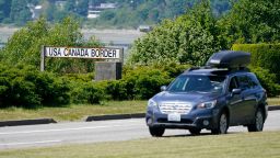 A car heads into the U.S. from Canada at the Peace Arch border crossing Tuesday, June 8, 2021, in Blaine, Wash. The border has been closed to nonessential travel since March 2020. (AP Photo/Elaine Thompson)