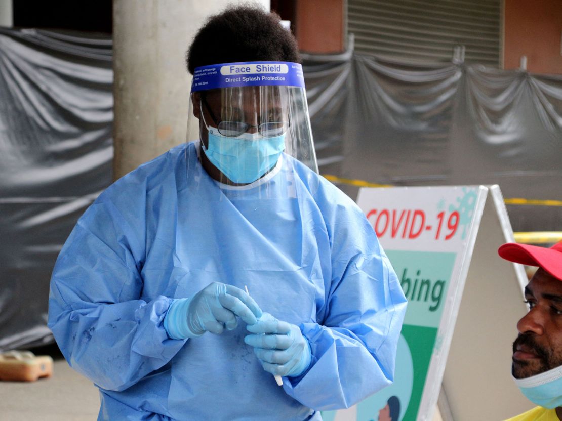 A health worker prepares to take a swab at a makeshift clinic in a sports stadium in Port Moresby on April 1, 2021. 