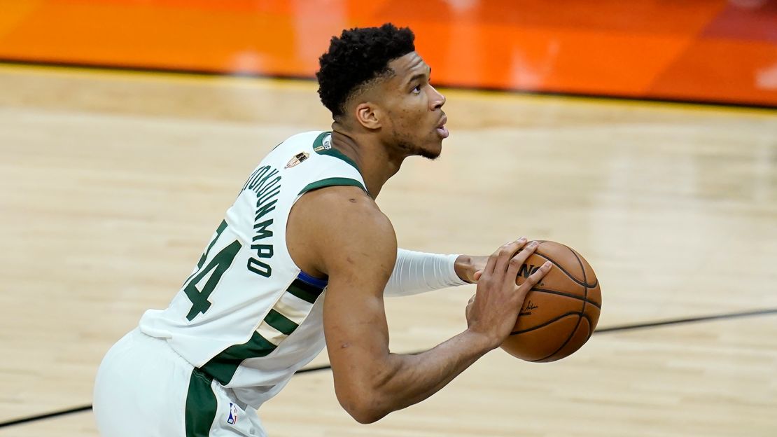 Milwaukee Bucks forward Giannis Antetokounmpo shoots a foul shot during the first half of Game 1 of basketball's NBA Finals against the Phoenix Suns, Tuesday, July 6, 2021, in Phoenix.