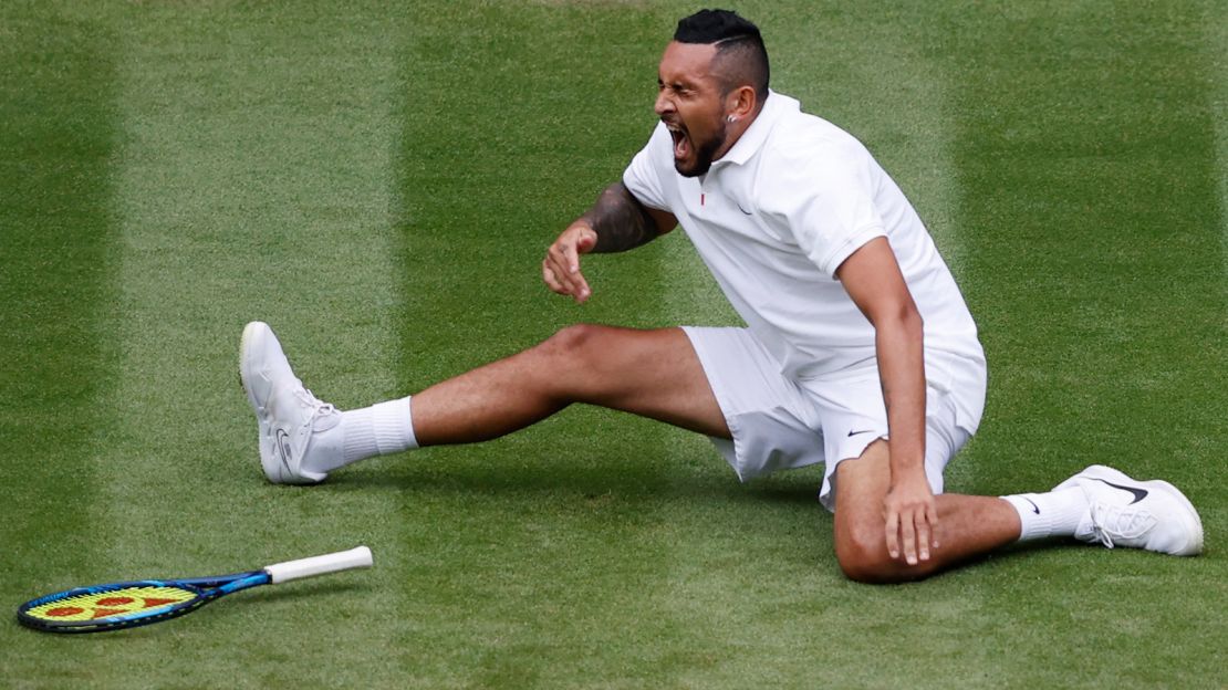 Australia's Nick Kyrgios falls as he returns to France's Ugo Humbert during their men's singles first round match on the third day of the 2021 Wimbledon Championships.