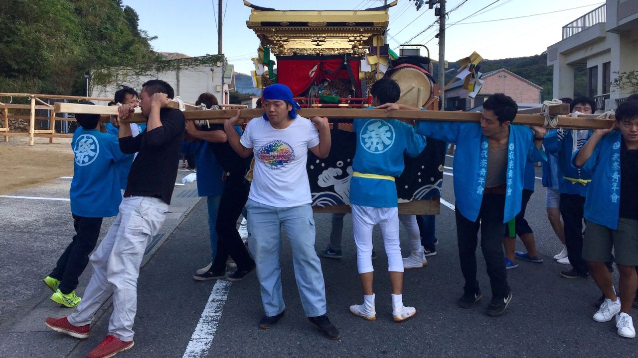 During an Ena matsuri (festival), men parade a Shinto shrine through the streets.