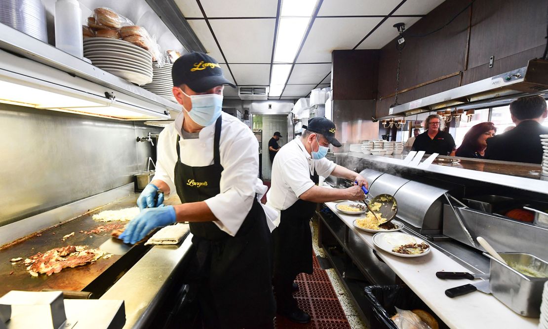 Kitchen staff prepare breakfast at Langer's Delicatessen-Restaurant in Los Angeles on June 15, California's first day of fully reopening its economy after some fifteen months of Covid restrictions.