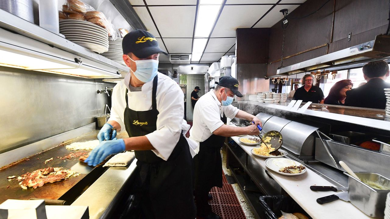Kitchen staff prepare breakfast at Langer's Delicatessen-Restaurant in Los Angeles on June 15, California's first day of fully reopening its economy after some fifteen months of Covid restrictions.