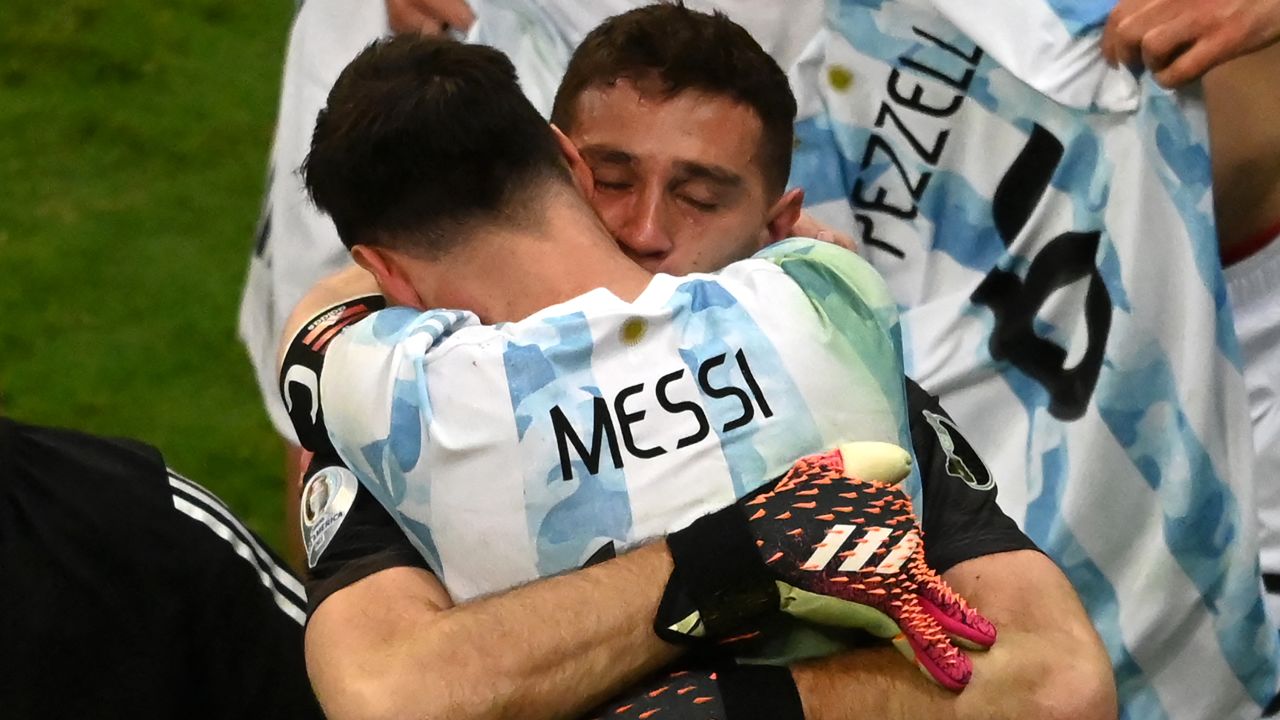 Argentina's goalkeeper Emiliano Martinez and Argentina's Lionel Messi embraces Emiliano Martinez after the goalkeeper's shootout heroics.