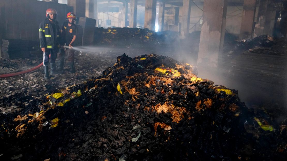 Firefighters work to douse the fire at the factory on Friday.