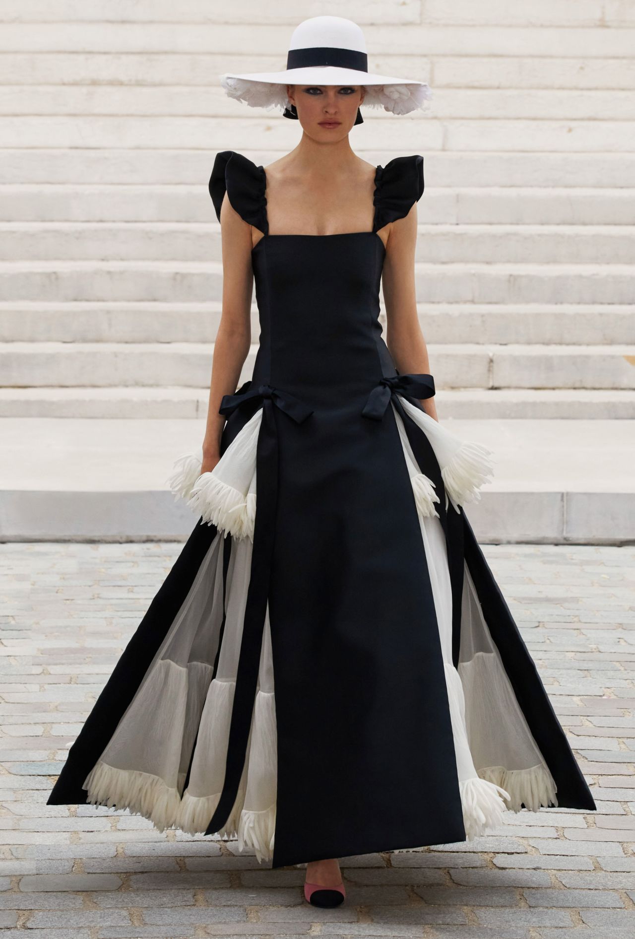 Chanel staged its show at the Palais Galliera, City of Paris Fashion Museum. Here, a look inspired by old portraits of Gabrielle Chanel dressed in black or white 1880s style dresses. 