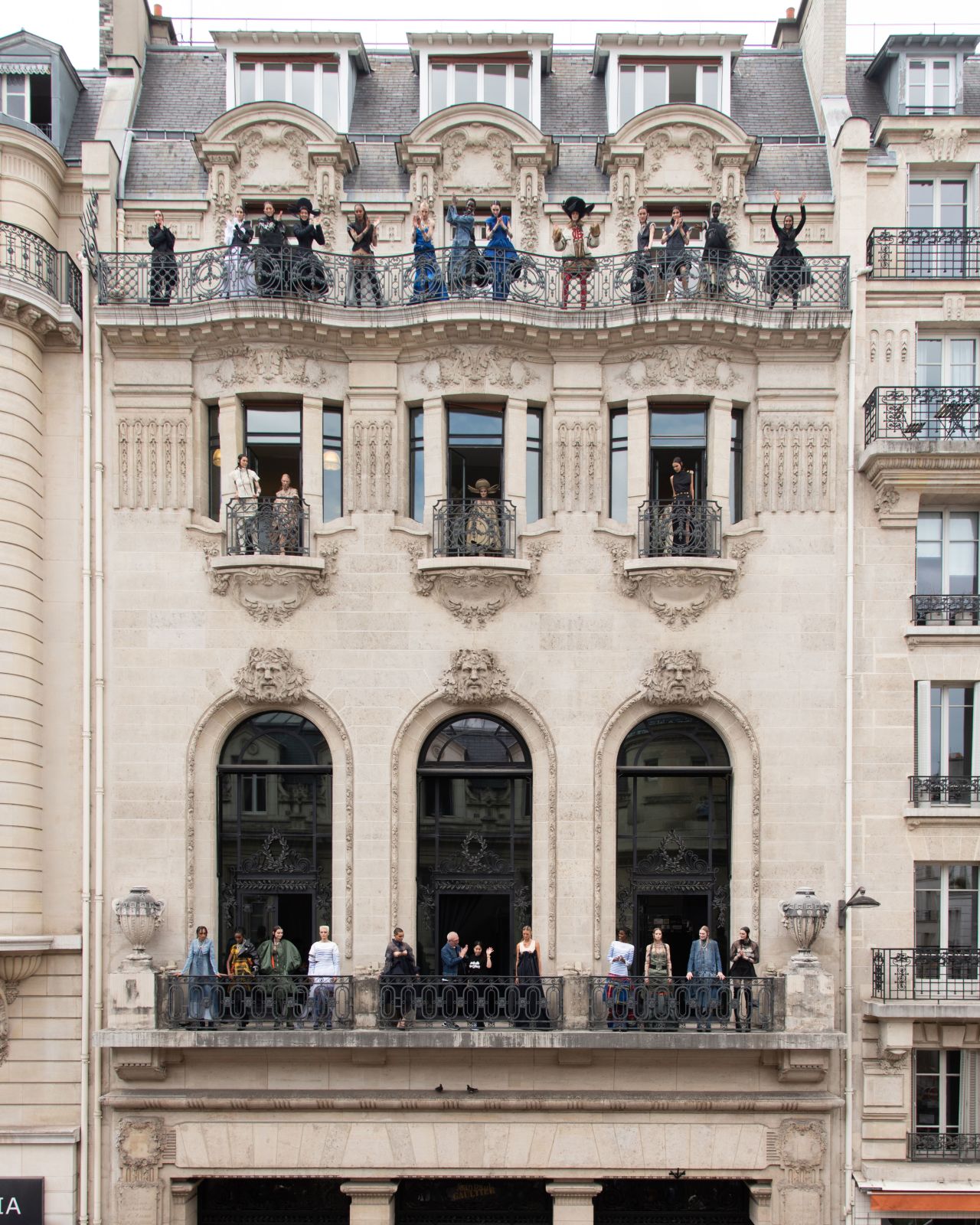 Here, Jean Paul Gaultier and models took to the balcony of the fashion house for a post-show salutation. 