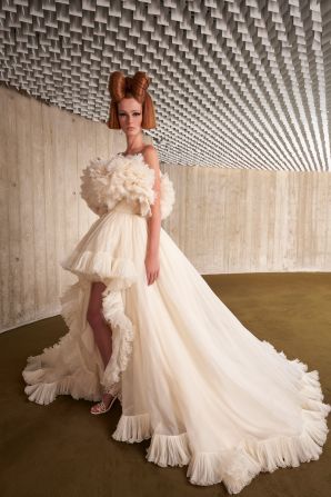 Big hair is the finishing touch on a series of undulating tulle frocks. 