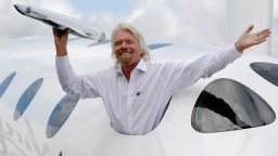 Entrepreneur Richard Branson waves a model of a LauncherOne cargo spacecraft from a window of an actual size model of SpaceShipTwo on display, after Virgin Galactic's LauncherOne announcement and news conference, at the Farnborough Airshow 2012 in southern England July 11, 2012.  REUTERS/Luke MacGregor  (BRITAIN - Tags: TRANSPORT BUSINESS TPX IMAGES OF THE DAY)