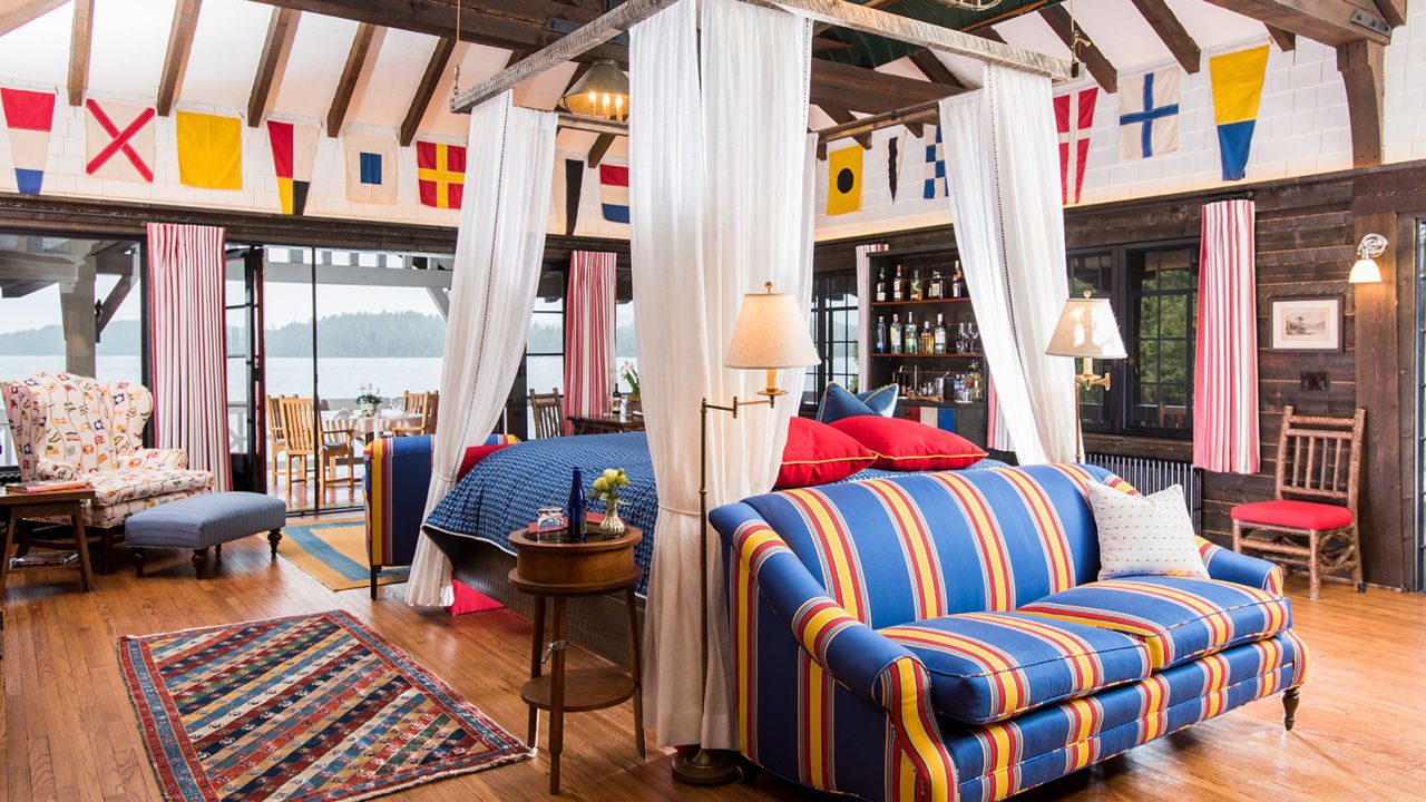 The interior of The Boathouse at The Point features nautical details. Outdoors, there are two hanging twin beds.
