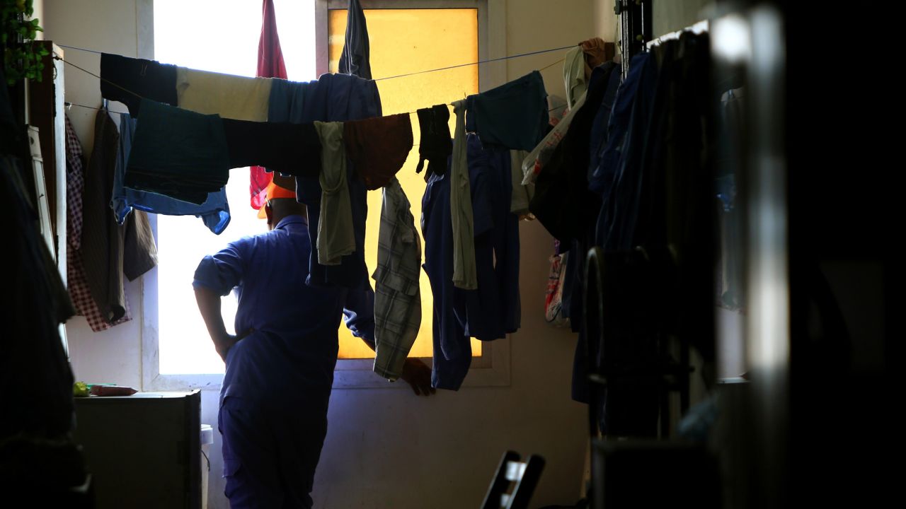 A worker from Nepal looks out the window of his room at a private camp housing foreign workers in Doha, on May 3, 2015. 