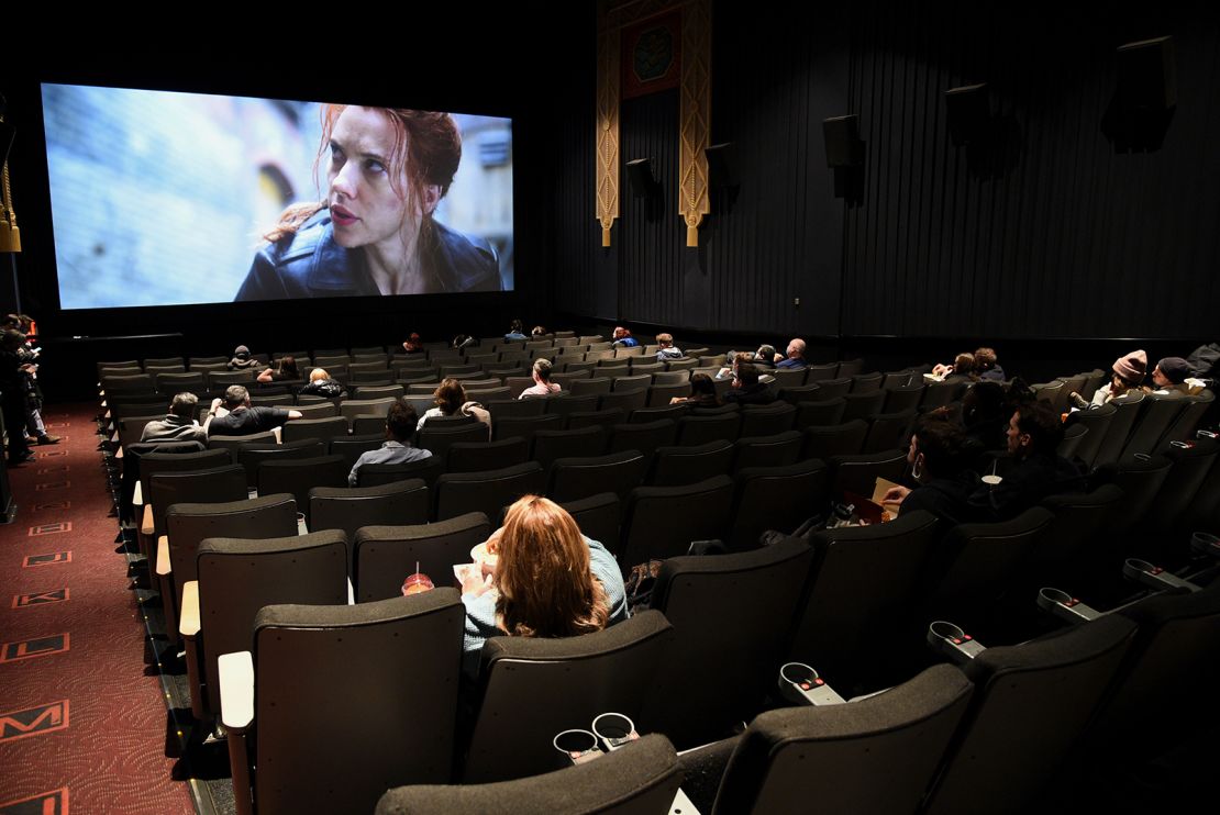 Moviegoers sit in a socially distant seating arrangement at the AMC Lincoln Square 13 theater on the first day of reopened theaters in New York on March 5, 2021. Cinemas are reopening; however,  as of May 2021, employment in the industry remains 63%, or 91,000 jobs, below where it entered the pandemic. 