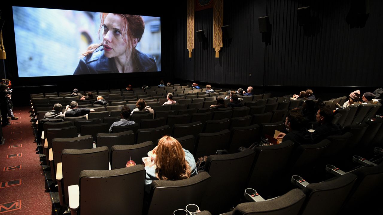 Moviegoers sit in a socially distant seating arrangement at the AMC Lincoln Square 13 theater on the first day of reopened theaters in New York on March 5, 2021. Cinemas are reopening; however,  as of May 2021, employment in the industry remains 63%, or 91,000 jobs, below where it entered the pandemic. 