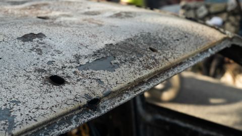 The charred shell of a car following the killing of Haiti's President.
