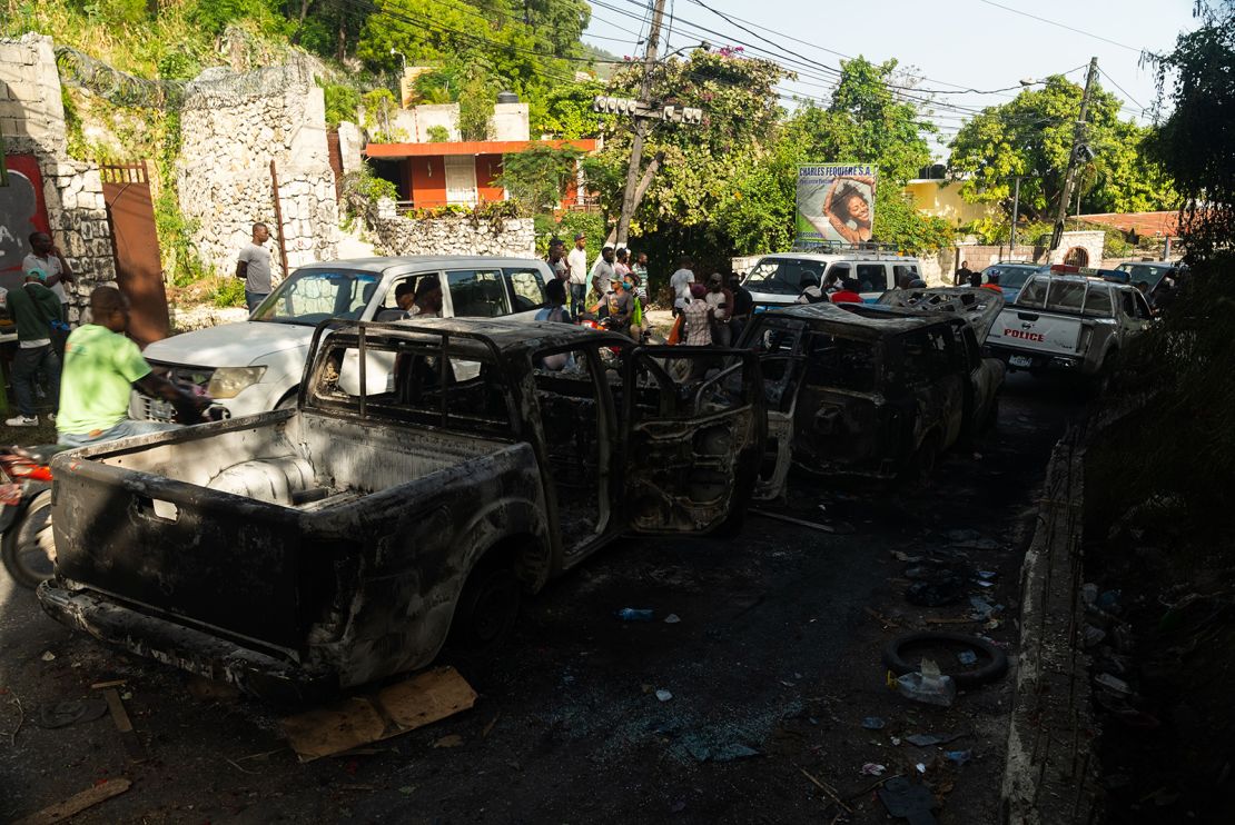 Burnt out cars line the street near the late President's residence in Haiti. 
