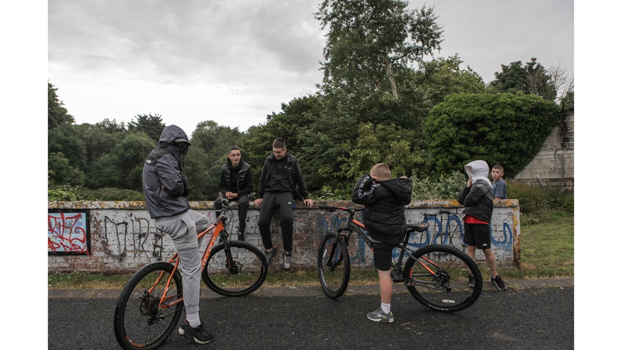 Youths gather near a "peace wall" in north Belfast's Alexandra Park. The peace wall, also referred to as a "separation barrier," is one of dozens of structures erected to separate predominantly republican and nationalist neighborhoods.