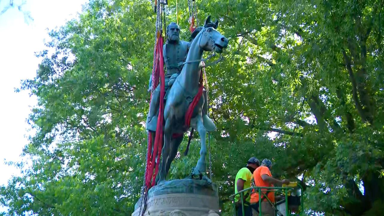 A crew prepares to lift a statue of Thomas J. "Stonewall" Jackson from its stone base in Charlottesville on Saturday.  