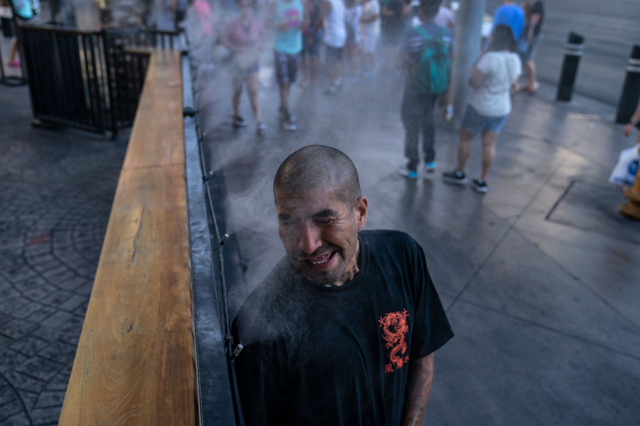 Golden Davis cools off in a mister along the Las Vegas Strip on July 9, 2021. The city tied its all-time temperature record of 117 degrees Fahrenheit over the weekend.