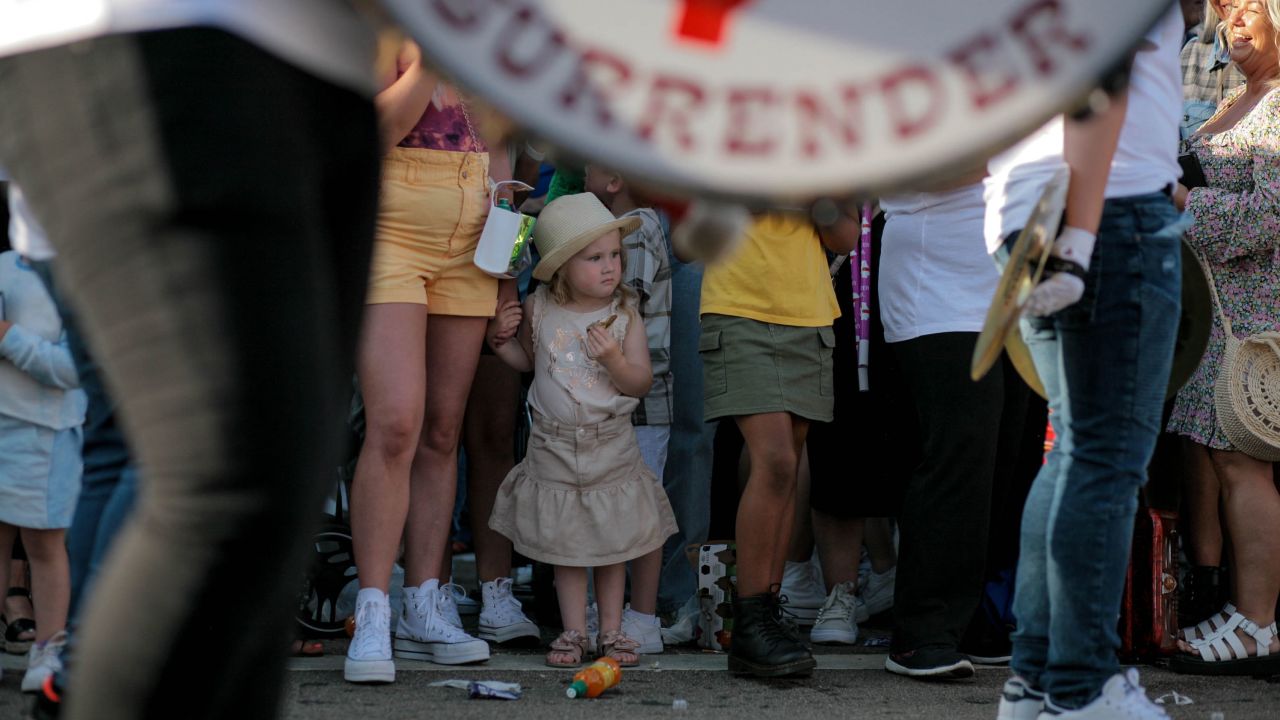 A young girl watches a loyalist marching band parade through west Belfast on Saturday.